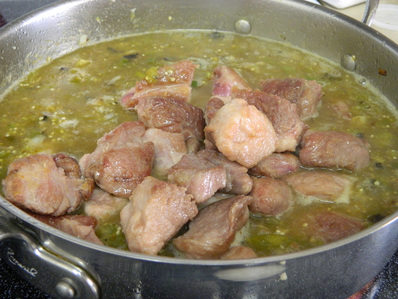 A one-pot Chile verde pork stew with steamed white rice Chile Verde con Carne (Chile Verde With Meat)