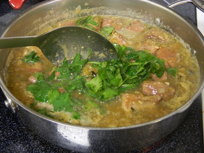 A one-pot Chile verde pork stew with steamed white rice Chile Verde con Carne (Chile Verde With Meat)
