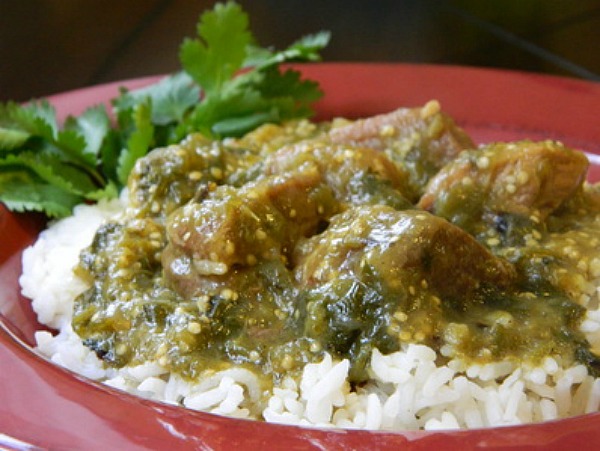 A one-pot Chile verde pork stew with steamed white rice Chile Verde con Carne (Chile Verde With Meat)