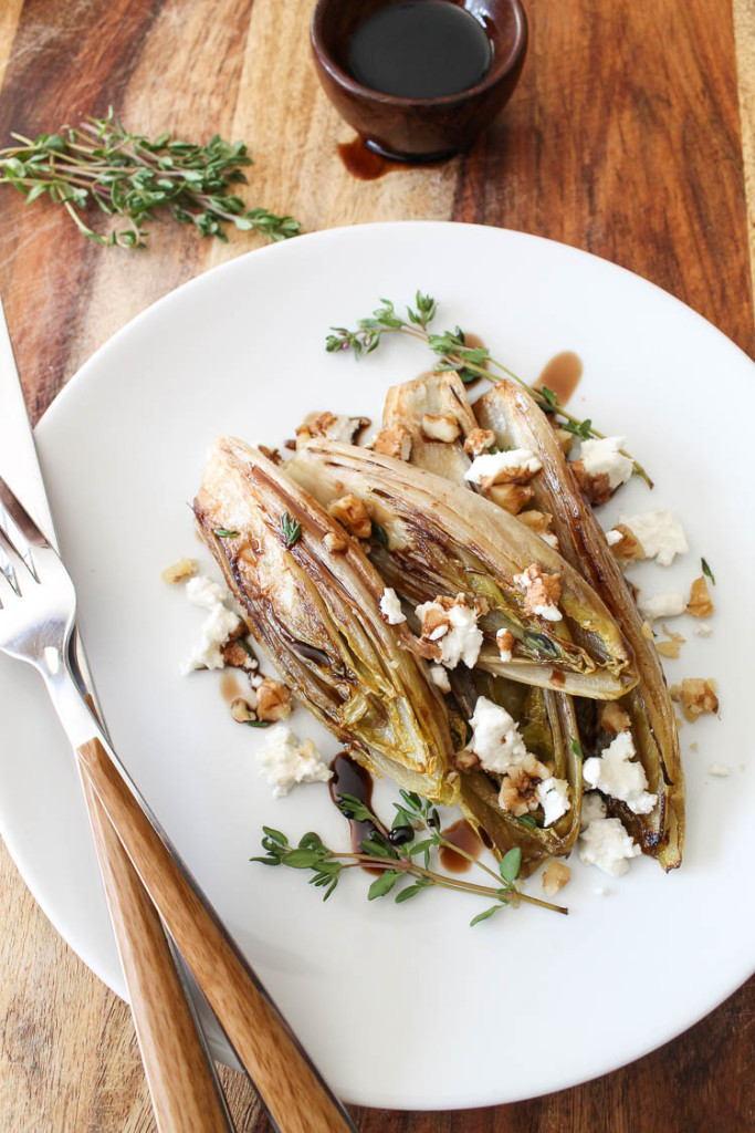 Sautéed Belgian endive halves with balsamic reduction, walnuts, and goat cheese.