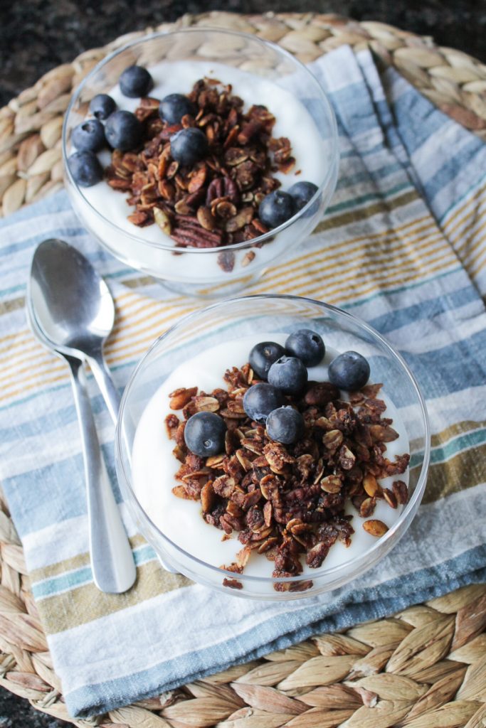Yogurt topped with Mexican chocolate granola and blueberries