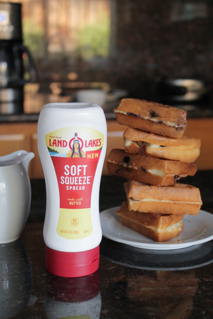 A stack of waffles next to Land O Lakes Soft Squeeze™ Spread