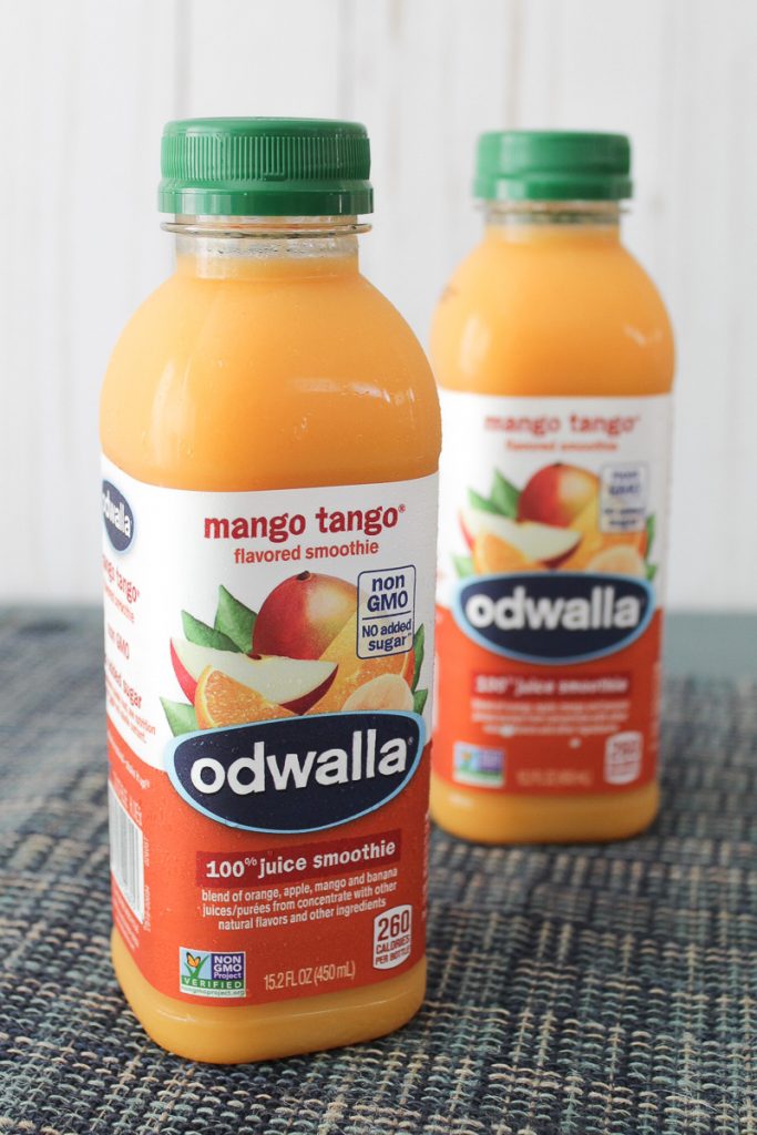 Close-up of two Odwalla® Mango Tango® bottles on a table.