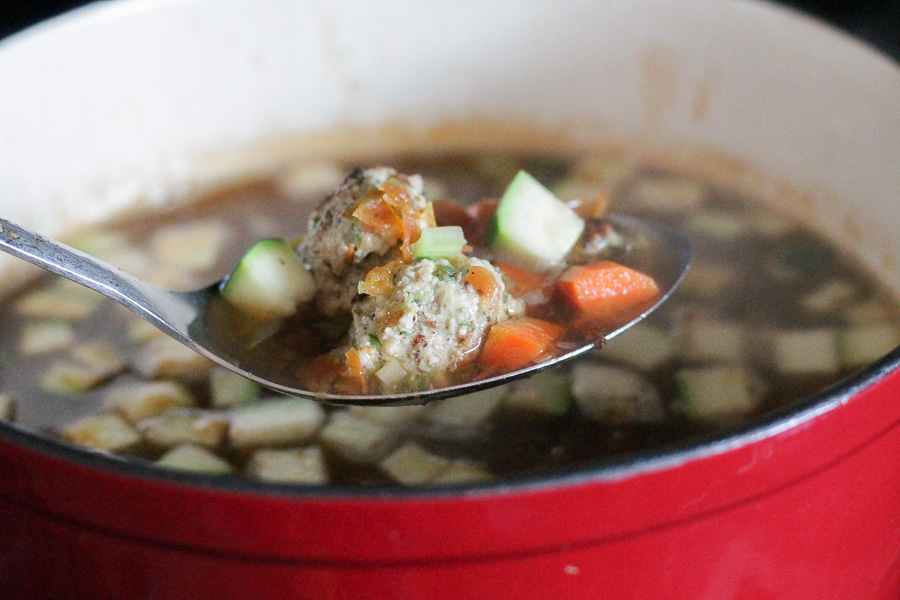 Turkey meatballs soup in a serving spoon.