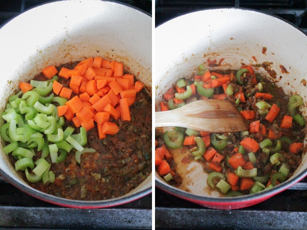 Chopped carrots and chopped celery being added to a pot of soup.