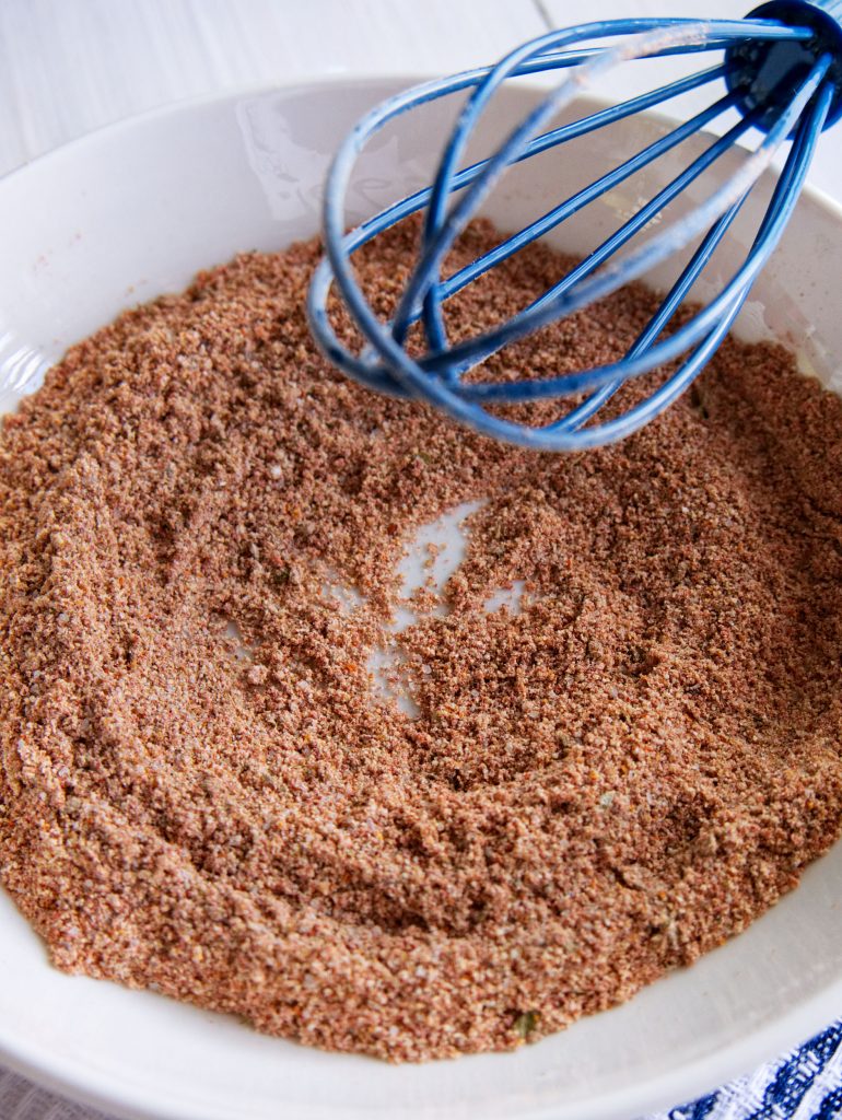 A close-up photo of taco seasoning being mixed in a bowl.